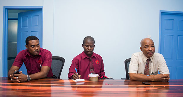 CEO of Eureka Medical Laboratory Andrew Boyle makes a point during an interview at the lab on Thursday. PRO of GNBS Lloyd David is at centre while another representative of the GNBS is at left.