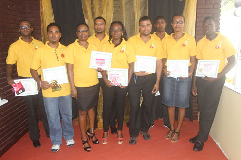 The awardees with their certificates and tokens of appreciation for their years of service (Photo by Sonell Nelson)