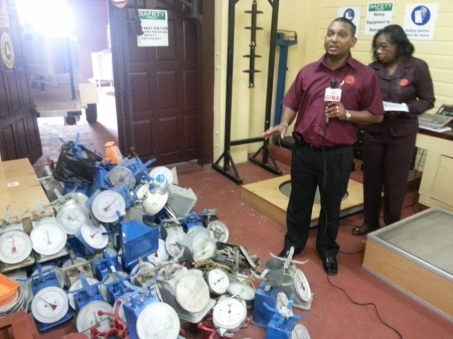 FLASH BACK: Head of the GNBS' Legal and Metrology Department, Shailendra Rai and GNBS' Director, Evadnie Enniss with a large number of unapproved scales that had been seized from market vendors stallholders.