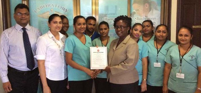 From left: Medical Director Dr. ChetramBudhu, General Manager Mrs. Ratna Budhu, Laboratory Manager Mrs. Kulwantie Mohabir, GNBS Mrs. Candelle Walcott-Bostwick and staff of Quest Medical Centre.